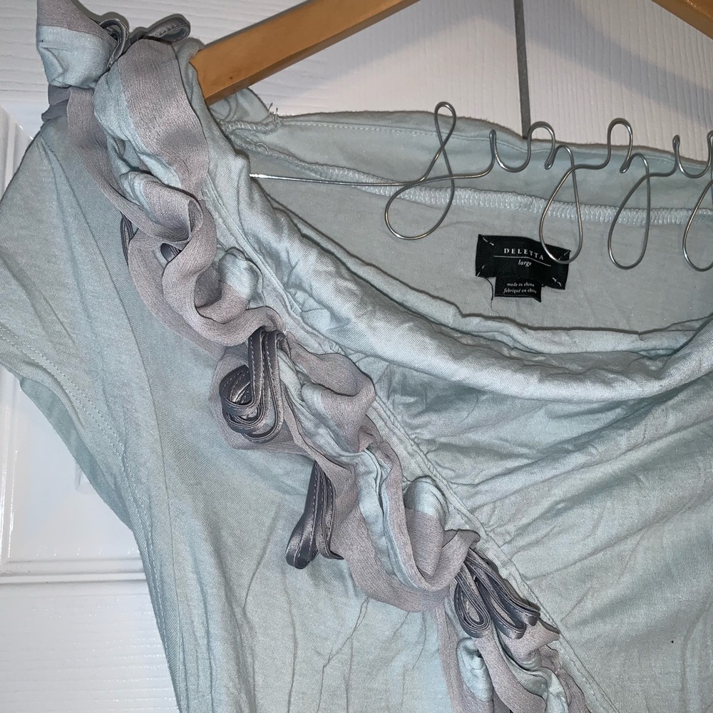Light teal top with flowery accent!